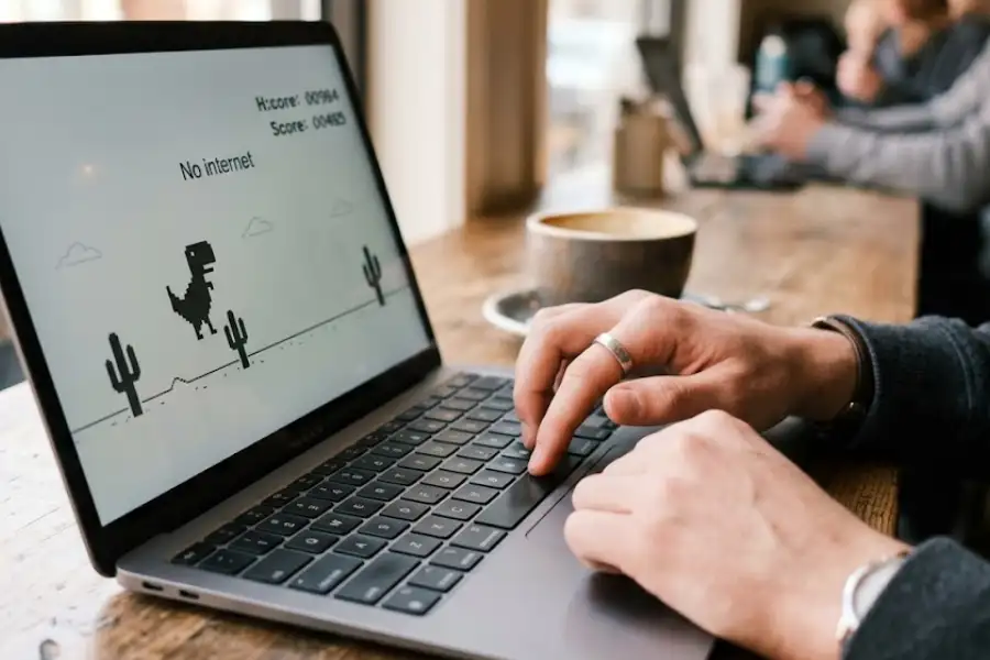 Chrome Easter Eggs: 25+ Hidden Games, Tricks, and Secrets You Need to Try 2 Chrome dinosaur game running on a computer screen with a cactus obstacle ahead