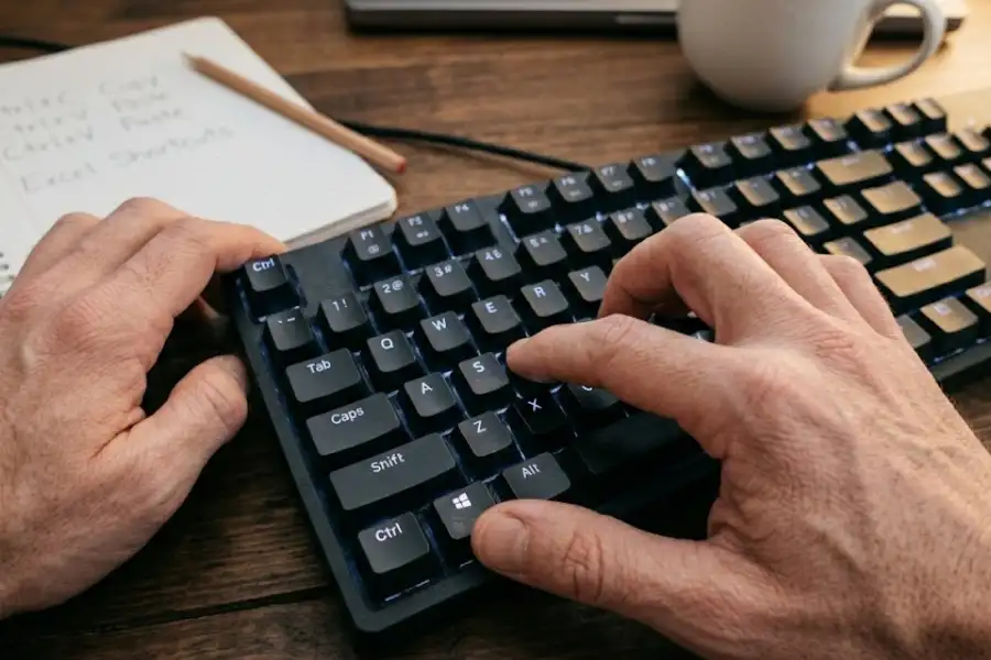 Close-up of hands pressing the Ctrl and C keys on a mechanical keyboard during real spreadsheet work