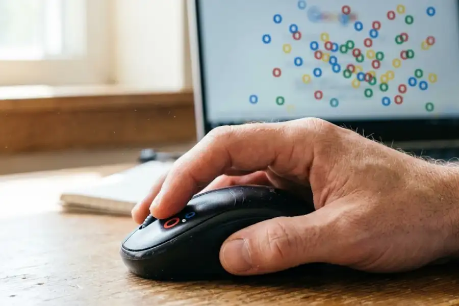 Zerg Rush Easter Egg: How to Play Google's Hidden Game in 2026 3 Close-up of a hand clicking a wireless mouse while playing the Zerg Rush easter egg on a laptop