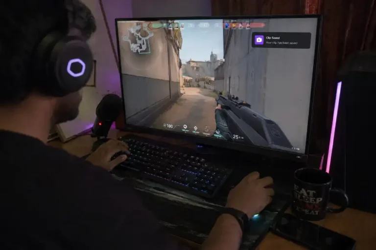 Game Clipping Software: 8 Best Free & Paid Tools for 2026 9 Gamer capturing a highlight clip on a PC setup with gameplay on screen and a visible replay notification