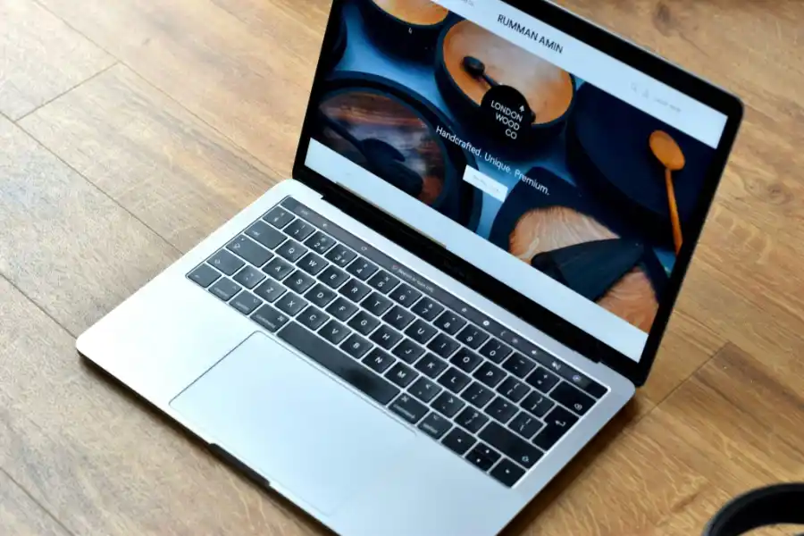 The Hidden Website Features That Make Online Shopping Less Frustrating 2 Laptop displaying a handcrafted wooden products website on its screen.