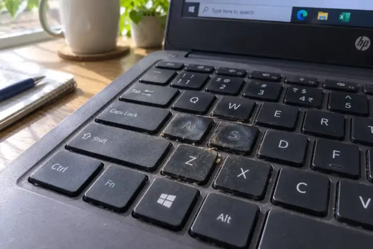 Some Keys on Keyboard Not Working? Here's the Real Fix 3 Close-up of some keys on a keyboard not working, with dust and crumbs stuck under the keycaps